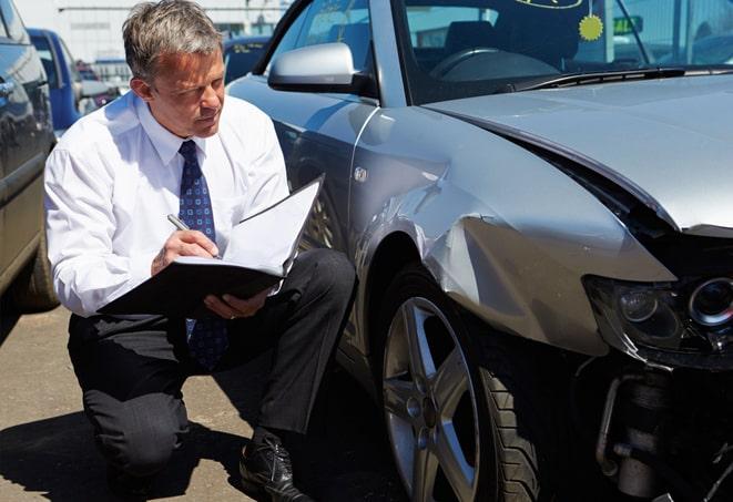 white car with insurance policy parked on city street